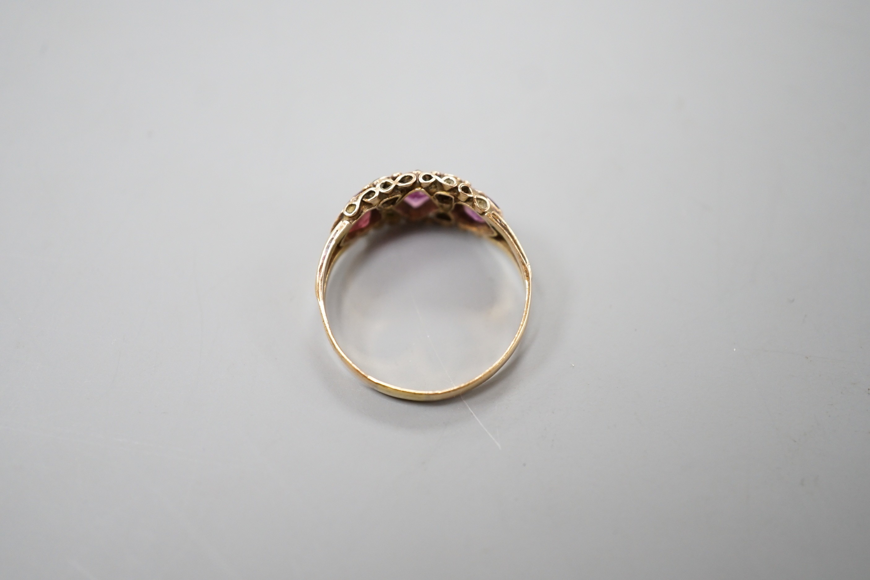 A Victorian gold, garnet? and emerald set half hoop ring, size N, gross weight 1.8 grams.